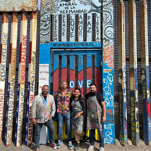 artists Enrique Chiu in fron tof mural